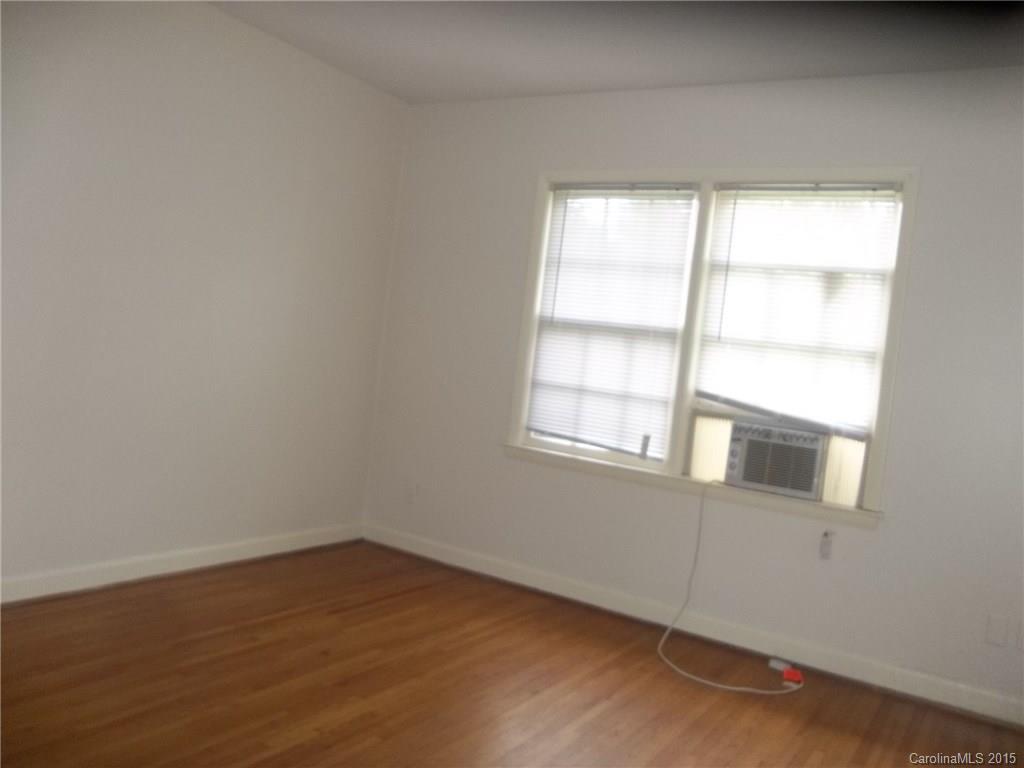 4227 Walker Road, Unit 4 Charlotte, NC 28211 - Photo 6 of 6 an empty room with wooden floor and windows