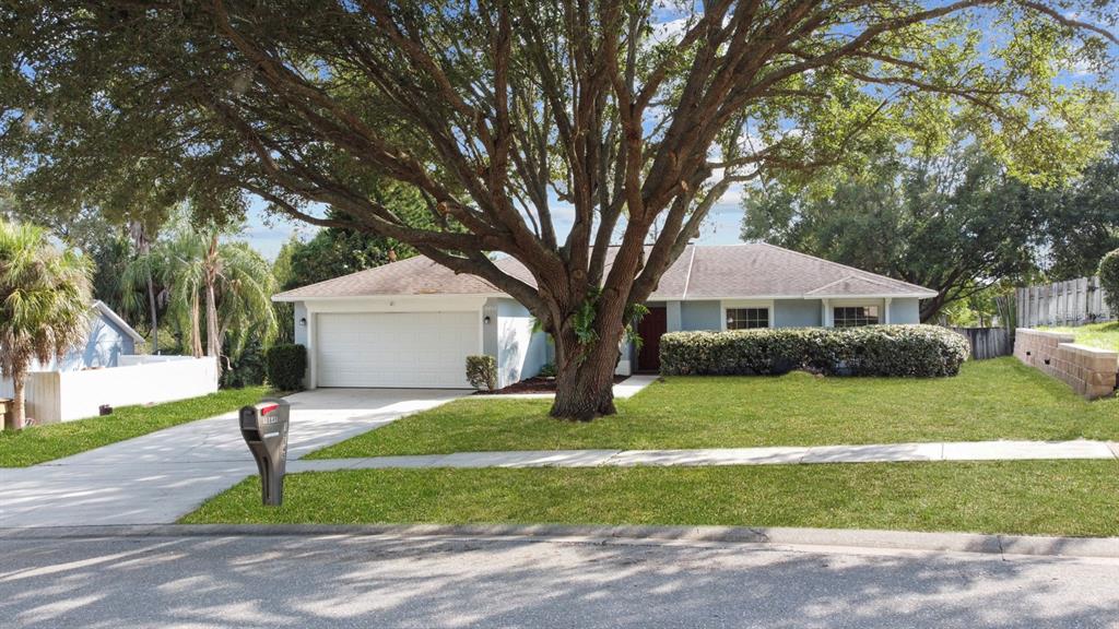 10645 Lake Ralph Drive Clermont, FL 34711 - Photo 1 of 1 a front view of a house with a yard and garage