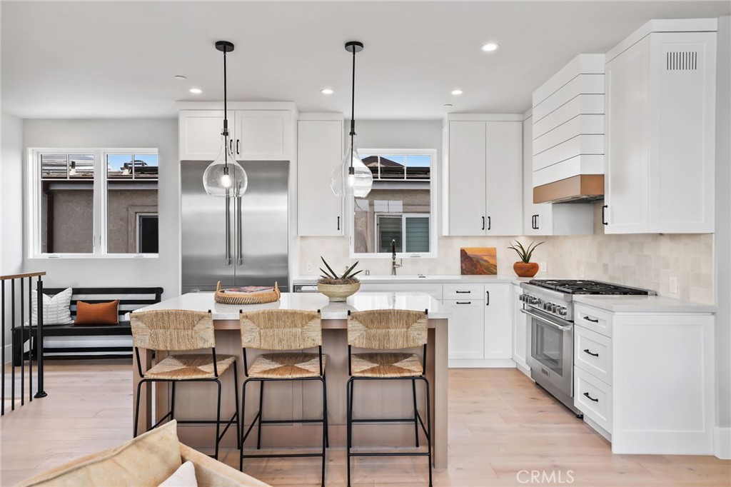 825 West Bay Avenue, Unit B Newport Beach, CA 92661 - Photo 1 of 30 a large kitchen with a large counter top space a sink stainless steel appliances and cabinets