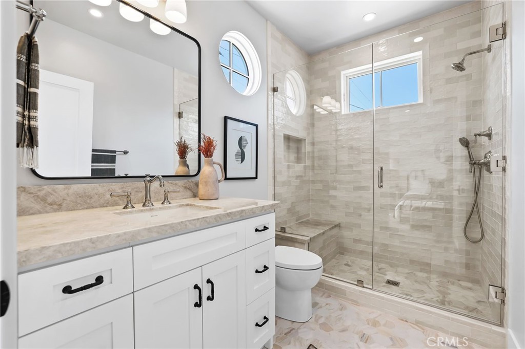 825 West Bay Avenue, Unit B Newport Beach, CA 92661 - Photo 12 of 30 a bathroom with a granite countertop sink toilet and shower