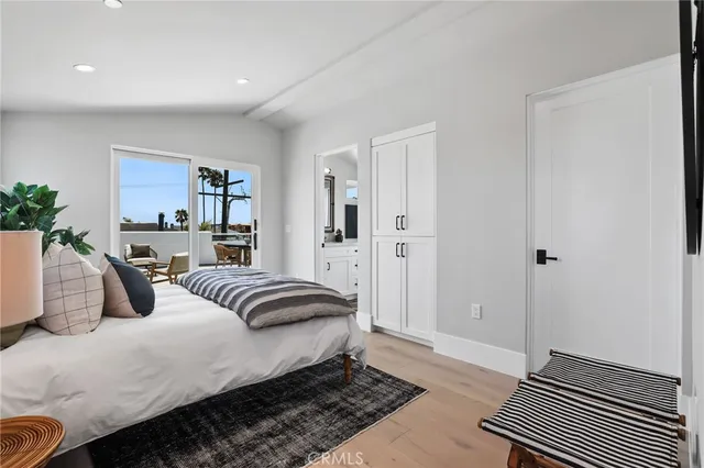 a spacious bedroom with a bed and a couch