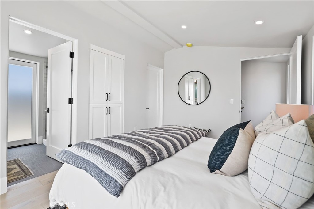 825 West Bay Avenue, Unit B Newport Beach, CA 92661 - Photo 17 of 30 a bedroom with a bed and a mirror