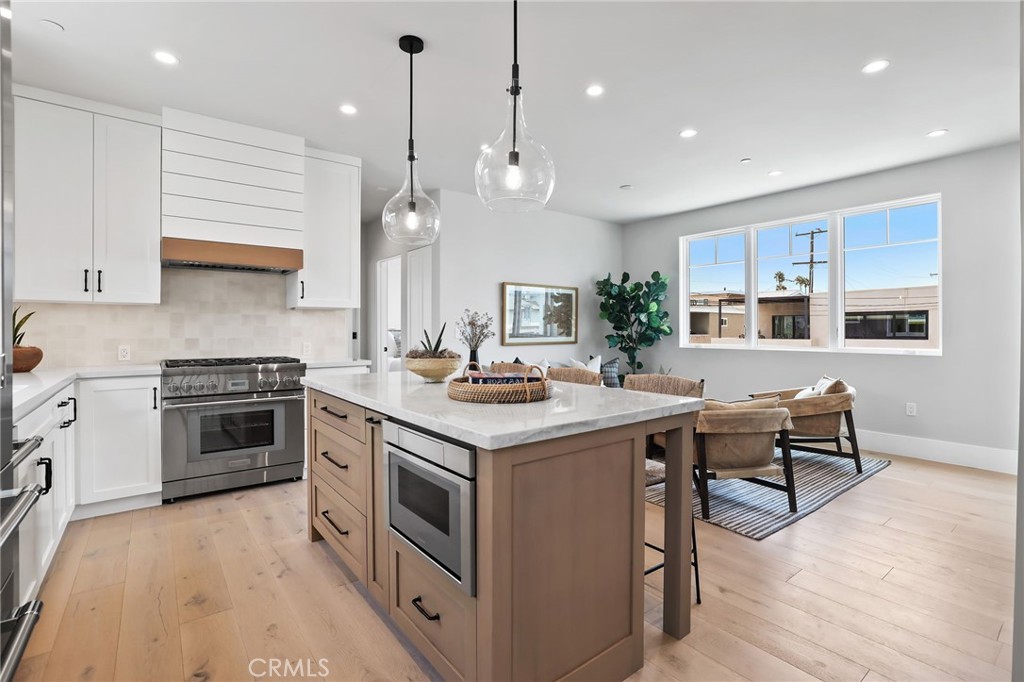 825 West Bay Avenue, Unit B Newport Beach, CA 92661 - Photo 2 of 30 a kitchen with a stove and a wooden floor
