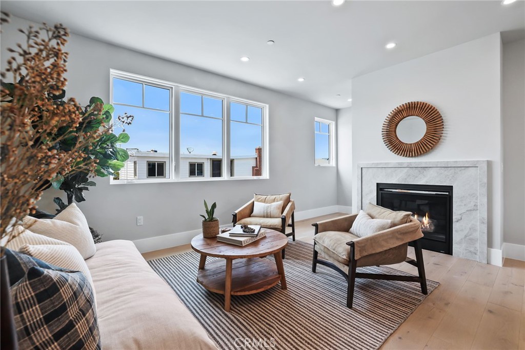 825 West Bay Avenue, Unit B Newport Beach, CA 92661 - Photo 3 of 30 a living room with furniture a fireplace and a potted plant