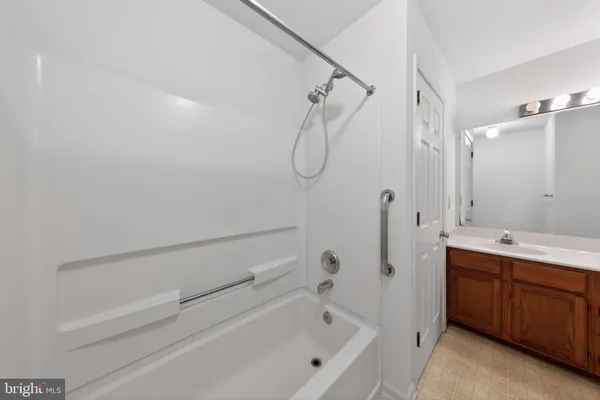 a bathroom with a bath tub a sink and a shower