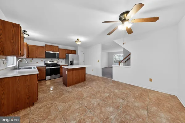 a kitchen with a refrigerator and a sink