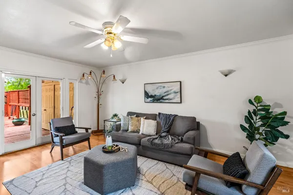 a living room with furniture and a chandelier