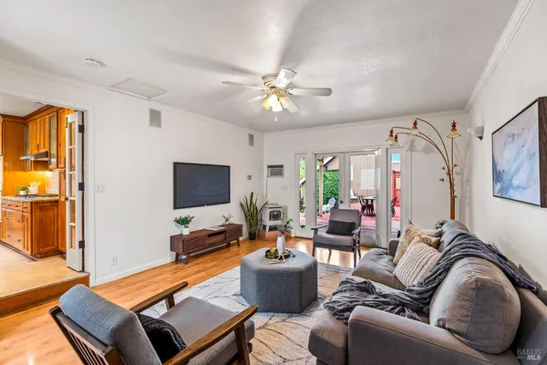 a living room with furniture and wooden floor