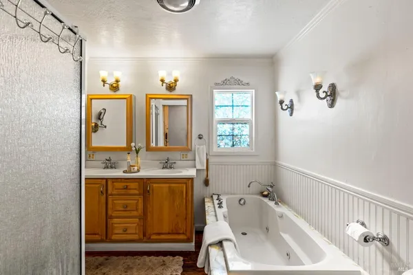 a bathroom with a tub sink and mirror