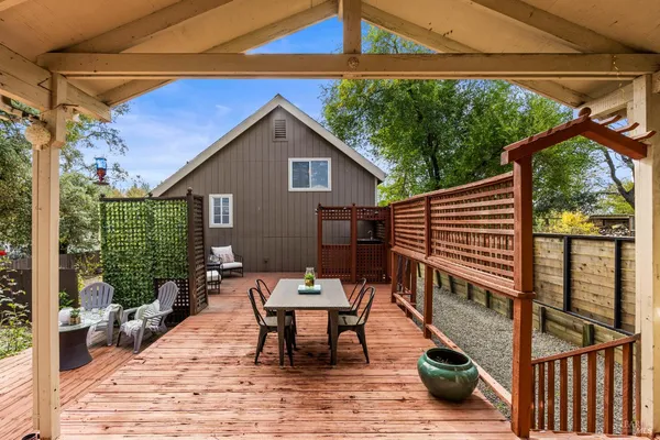 a view of a patio with a table and chairs under an umbrella