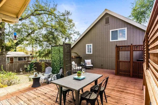 a view of a house with backyard and sitting area