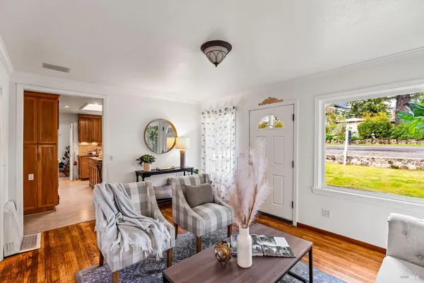 a view of a livingroom with furniture window and wooden floor