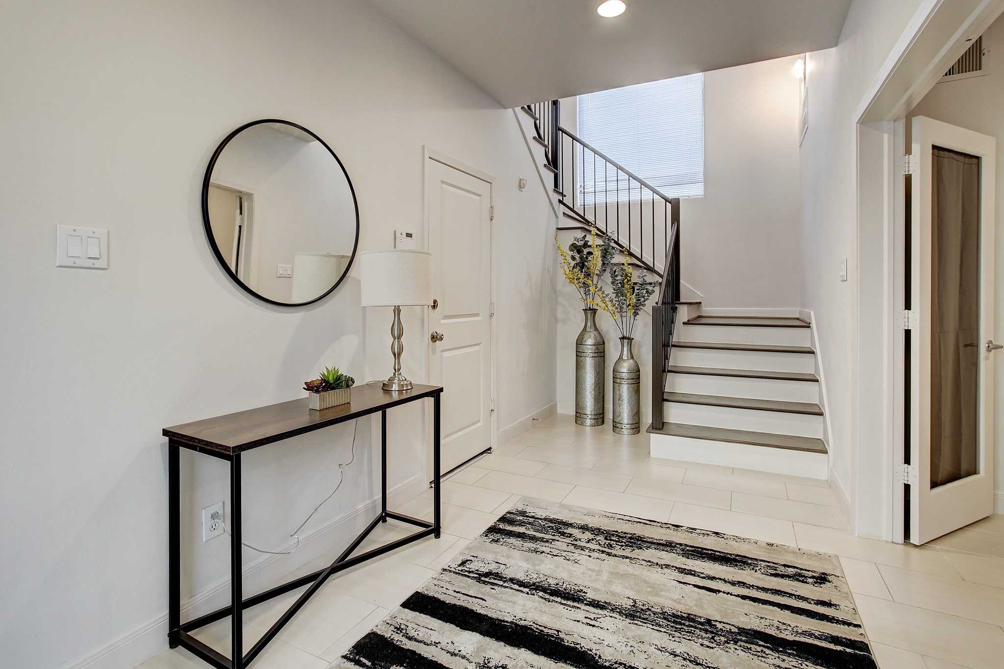 902 Roy Street Houston, TX 77007 - Photo 16 of 47 a view of a hallway with wooden floor and white walls