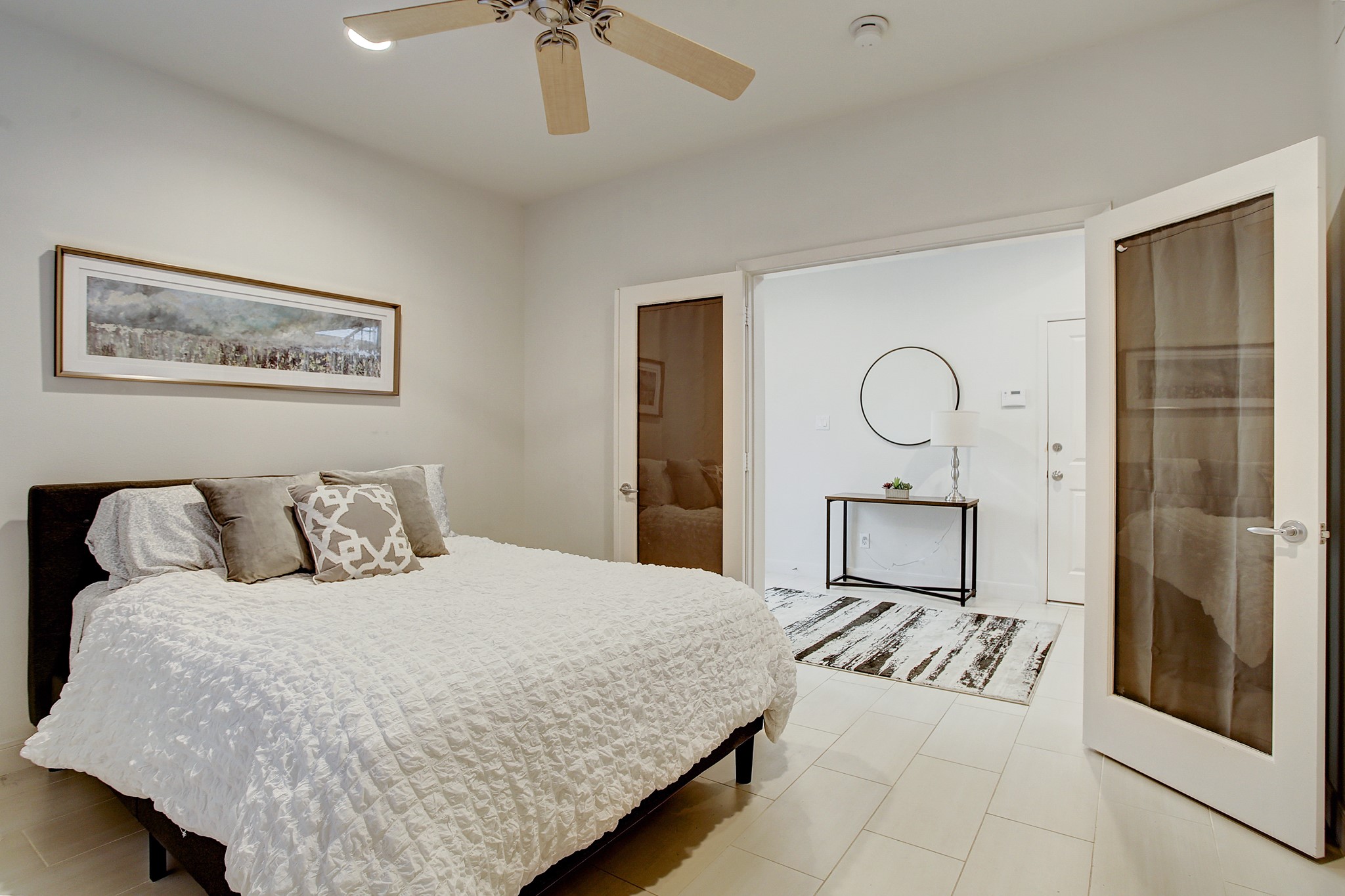 902 Roy Street Houston, TX 77007 - Photo 18 of 47 a bedroom with a large bed and a chandelier