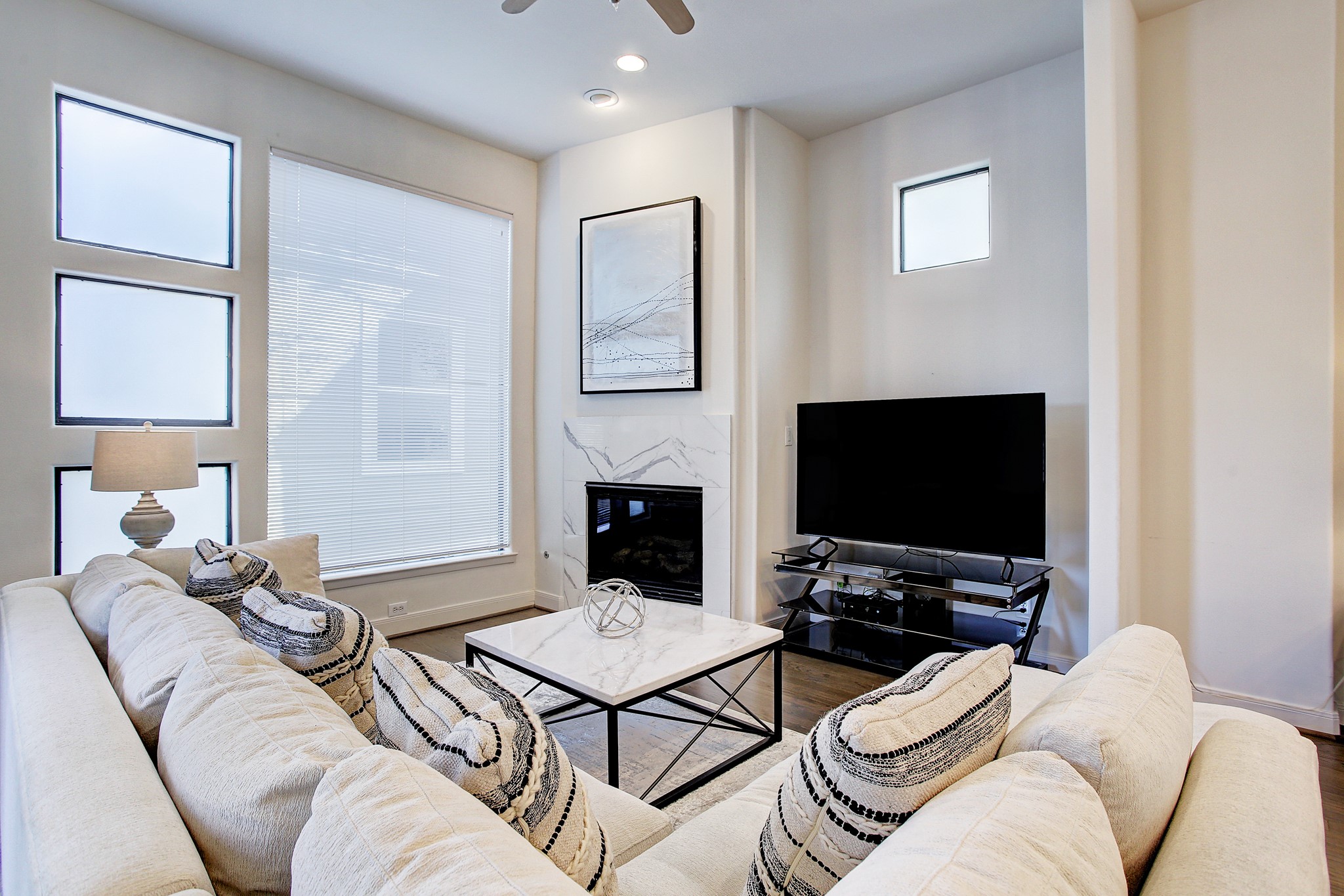 902 Roy Street Houston, TX 77007 - Photo 3 of 47 a living room with furniture a flat screen tv and a fireplace