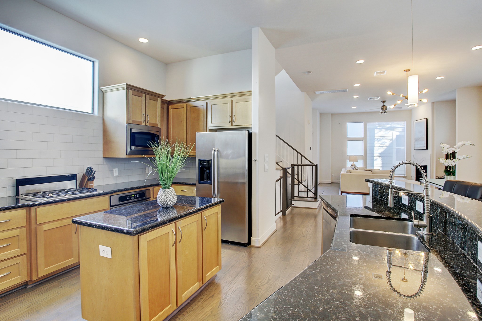 902 Roy Street Houston, TX 77007 - Photo 10 of 47 a kitchen with stainless steel appliances granite countertop a sink a stove a refrigerator cabinets and living room view