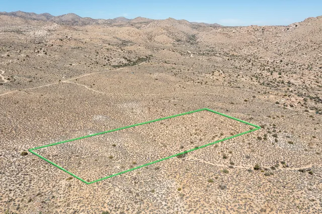 a view of a dry mountains with mountains in the background