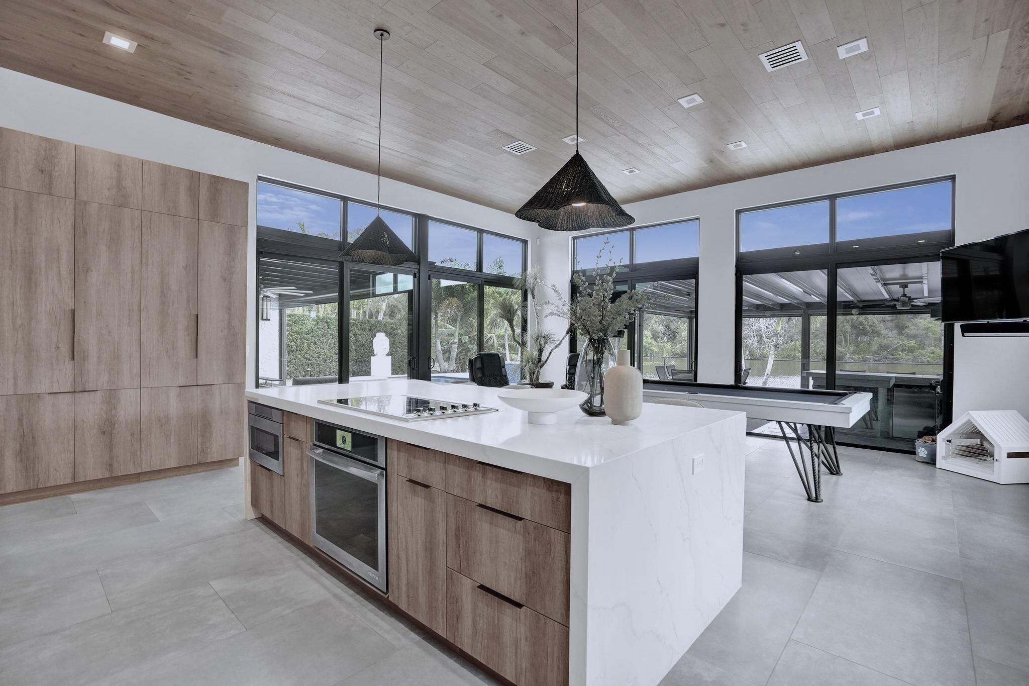 3222 Ridge Trace Davie, FL 33328 - Photo 19 of 77 a open kitchen with stainless steel appliances granite countertop a stove and a view of living room