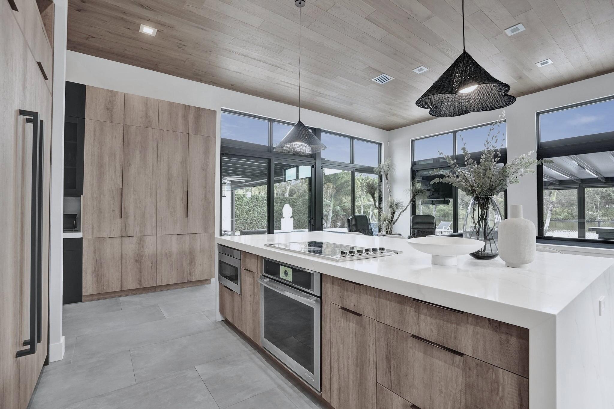 3222 Ridge Trace Davie, FL 33328 - Photo 20 of 77 a kitchen with stainless steel appliances granite countertop a sink and a refrigerator
