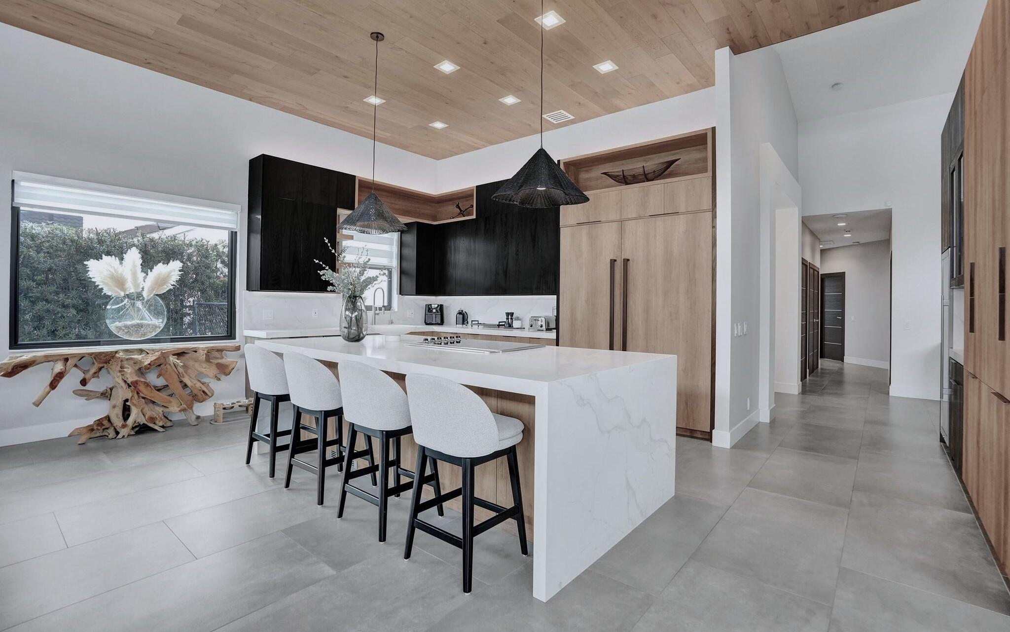 3222 Ridge Trace Davie, FL 33328 - Photo 23 of 77 a kitchen with stainless steel appliances kitchen island granite countertop a refrigerator and a dining table