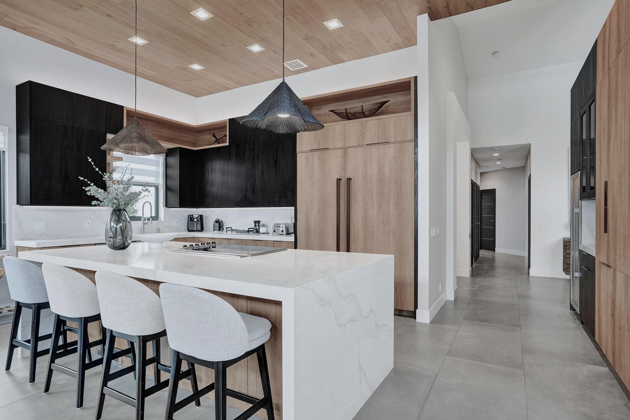 3222 Ridge Trace Davie, FL 33328 - Photo 24 of 77 a kitchen with stainless steel appliances kitchen island granite countertop a sink a microwave and a refrigerator