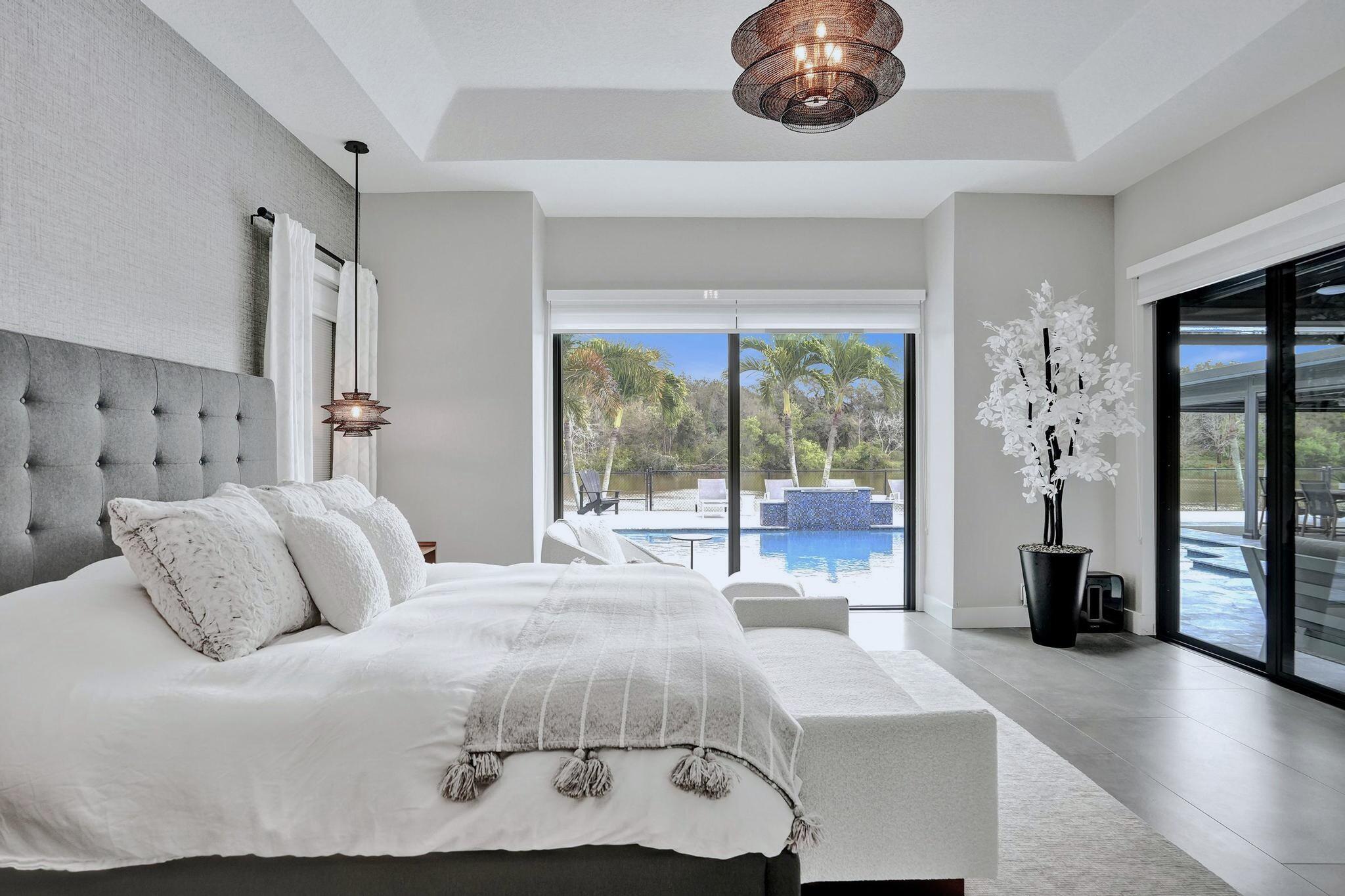 3222 Ridge Trace Davie, FL 33328 - Photo 31 of 77 a bedroom with a large bed and a large window