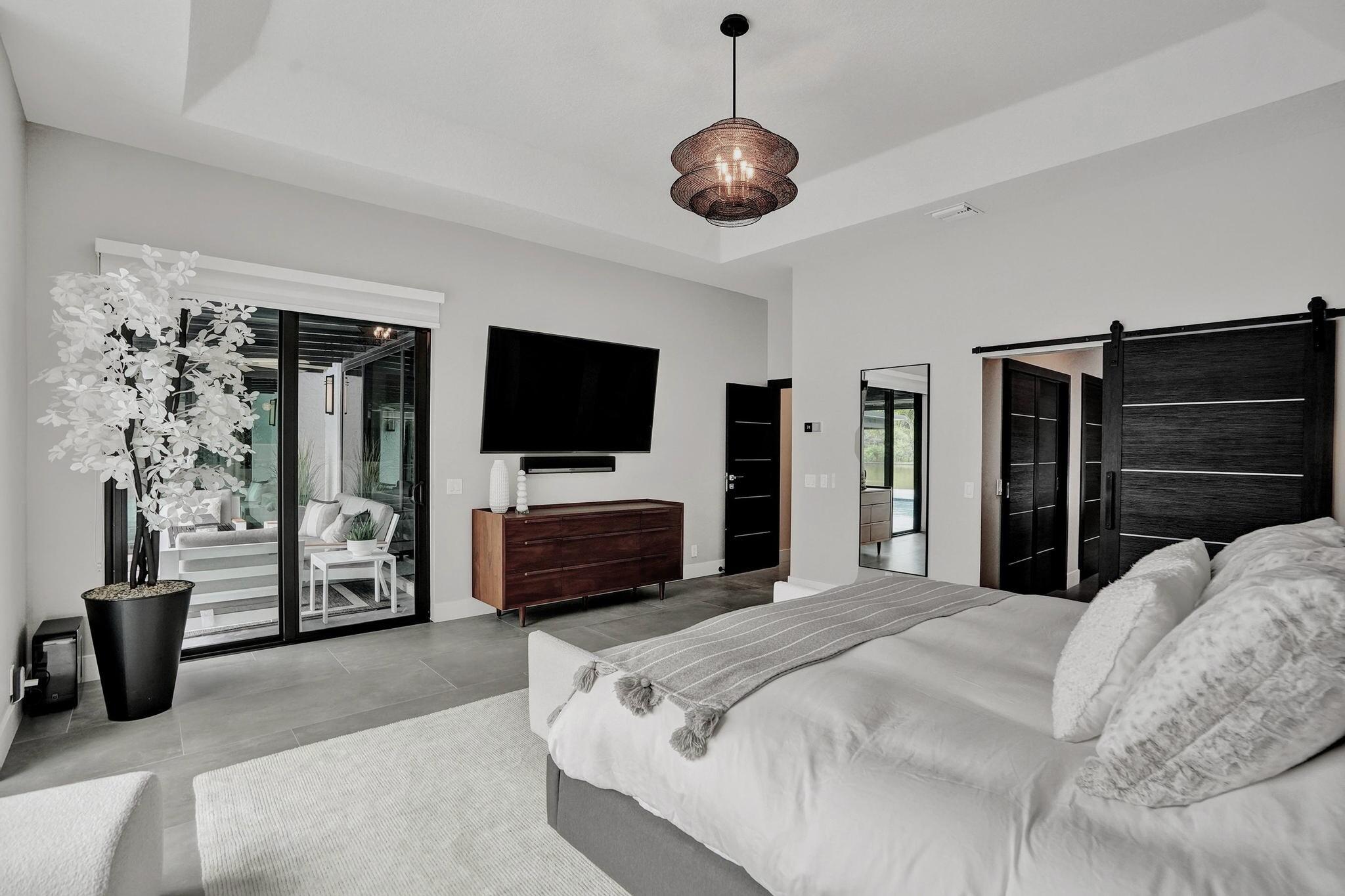 3222 Ridge Trace Davie, FL 33328 - Photo 33 of 77 a bedroom with a bed and a flat tv screen on dresser