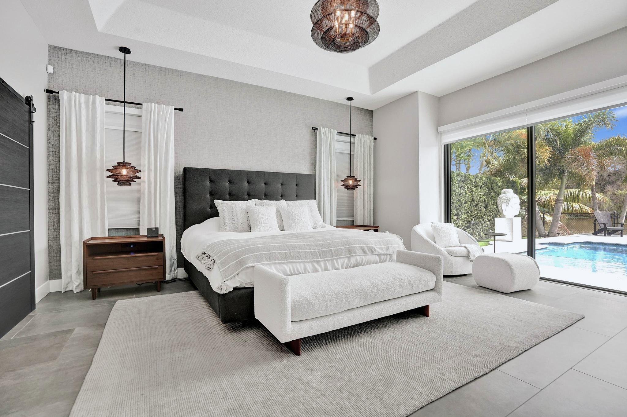 3222 Ridge Trace Davie, FL 33328 - Photo 34 of 77 a bedroom with a large bed and a chandelier