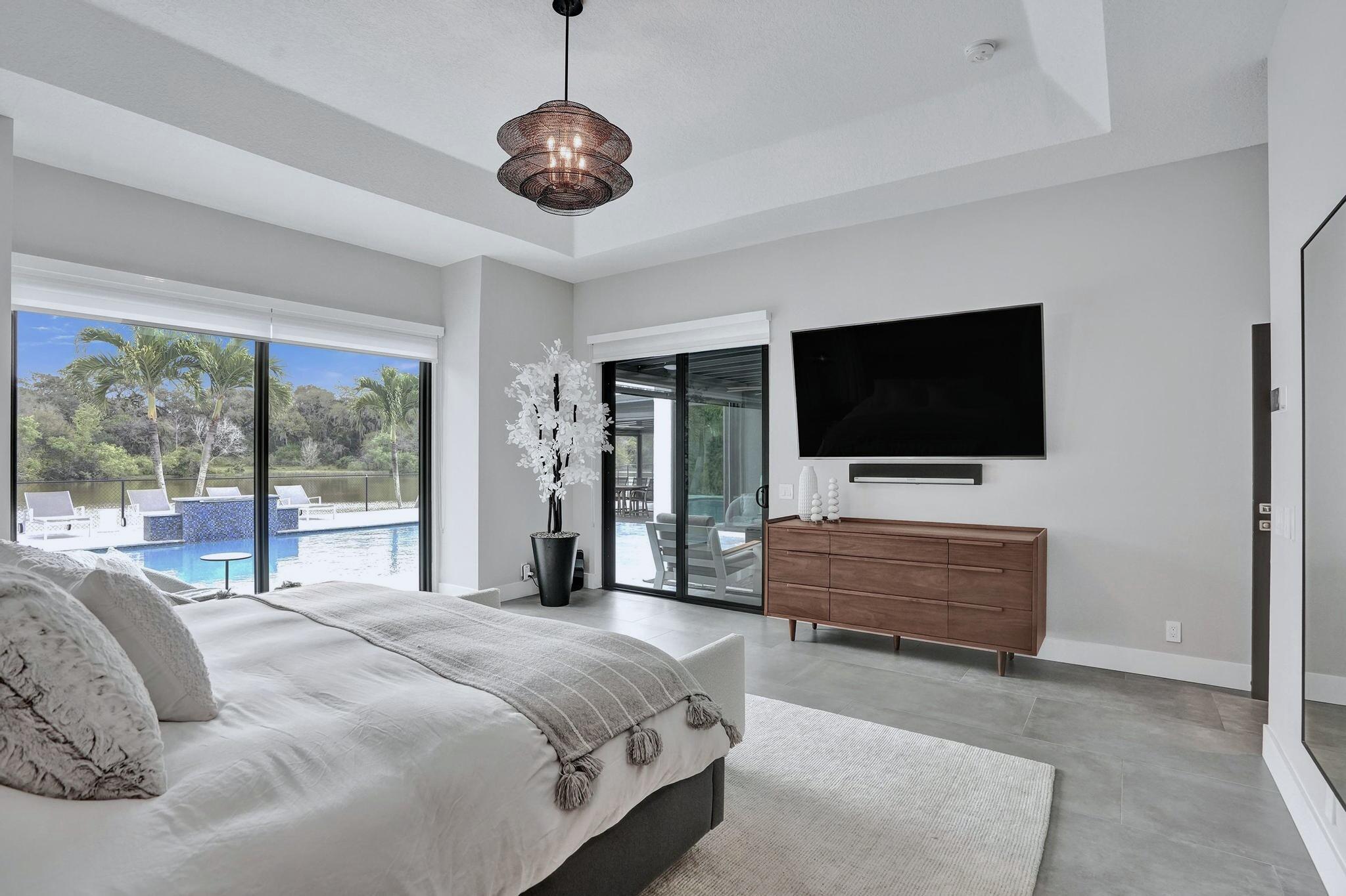 3222 Ridge Trace Davie, FL 33328 - Photo 35 of 77 a bedroom with a bed and a flat screen tv