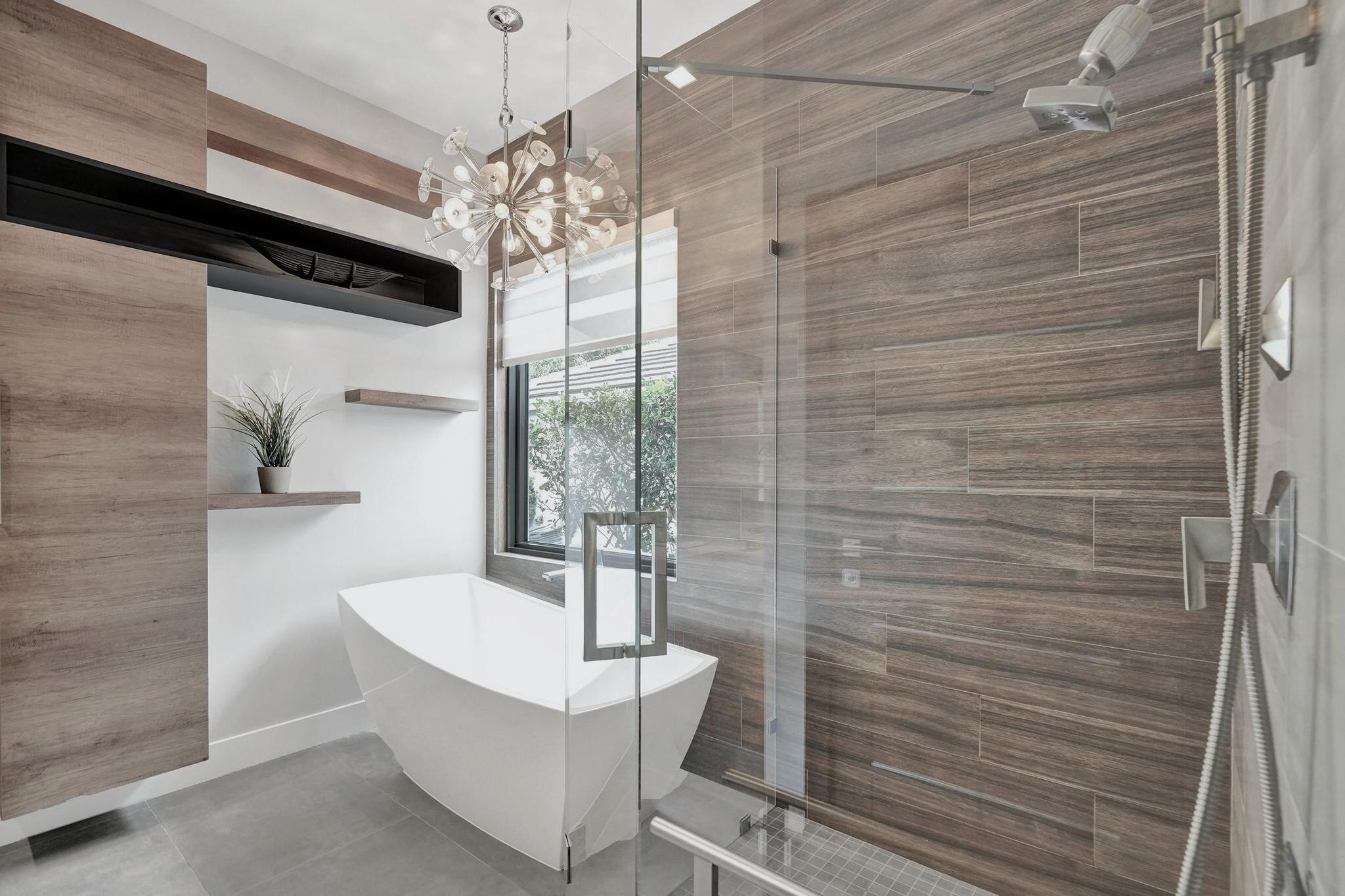 3222 Ridge Trace Davie, FL 33328 - Photo 43 of 77 a bathroom with a sink a bathtub and chandelier