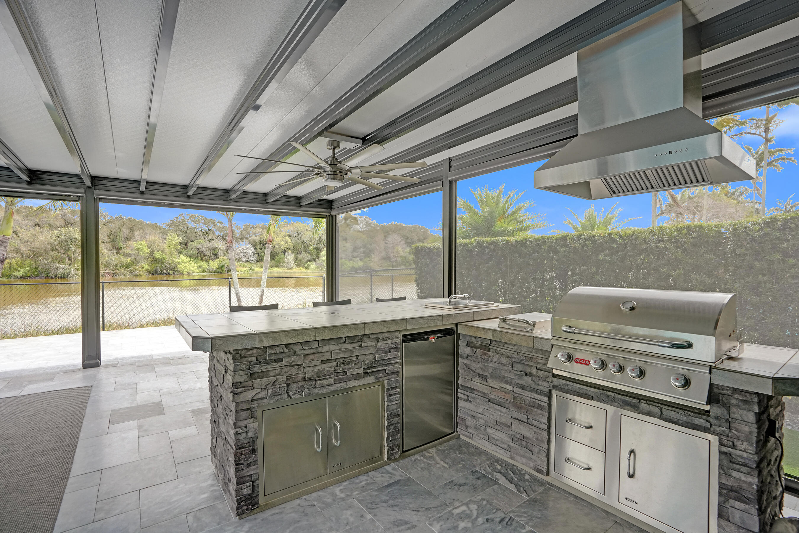 3222 Ridge Trace Davie, FL 33328 - Photo 54 of 77 a kitchen with a stove a sink and a refrigerator
