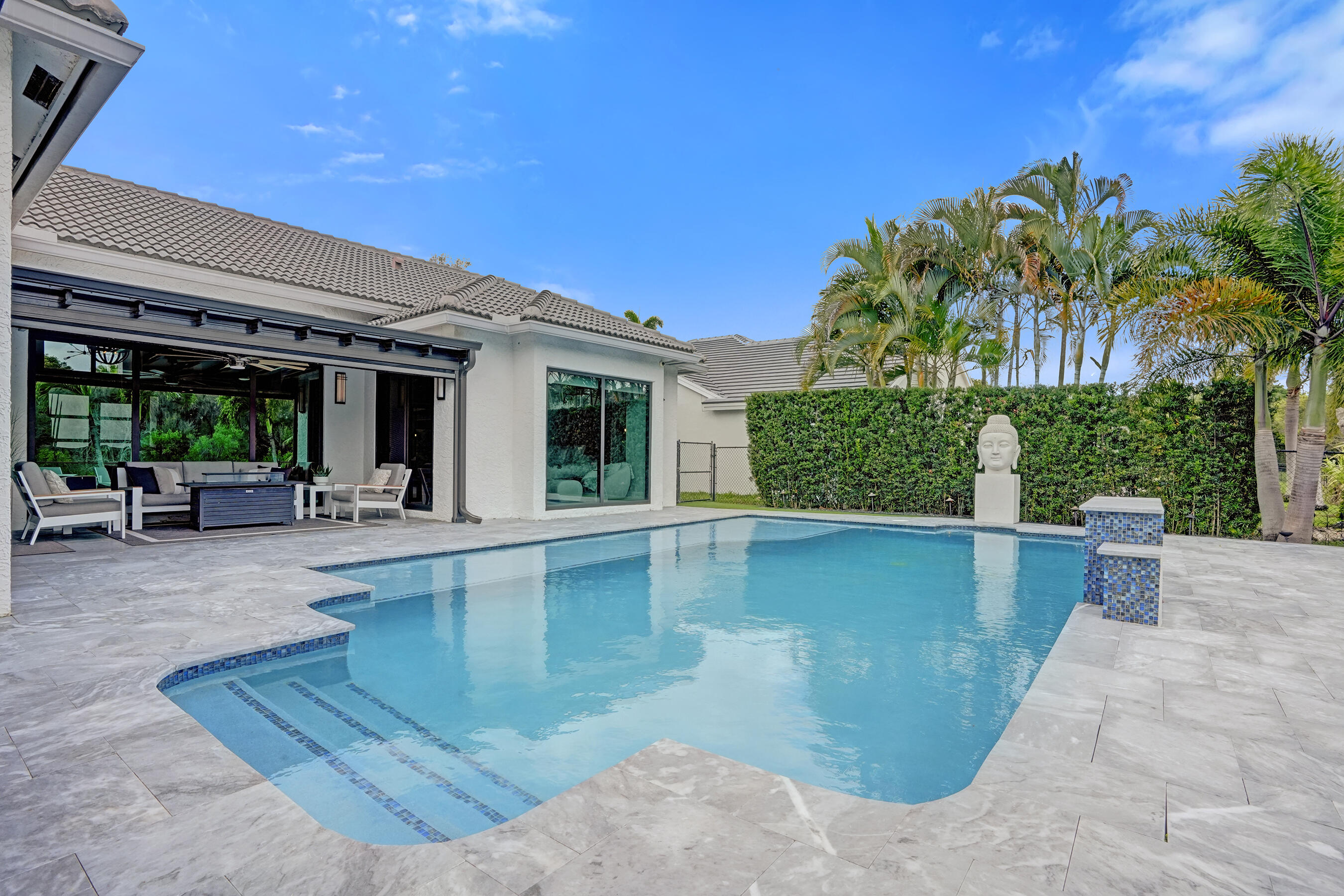 3222 Ridge Trace Davie, FL 33328 - Photo 63 of 77 a view of a swimming pool with outdoor seating and plants