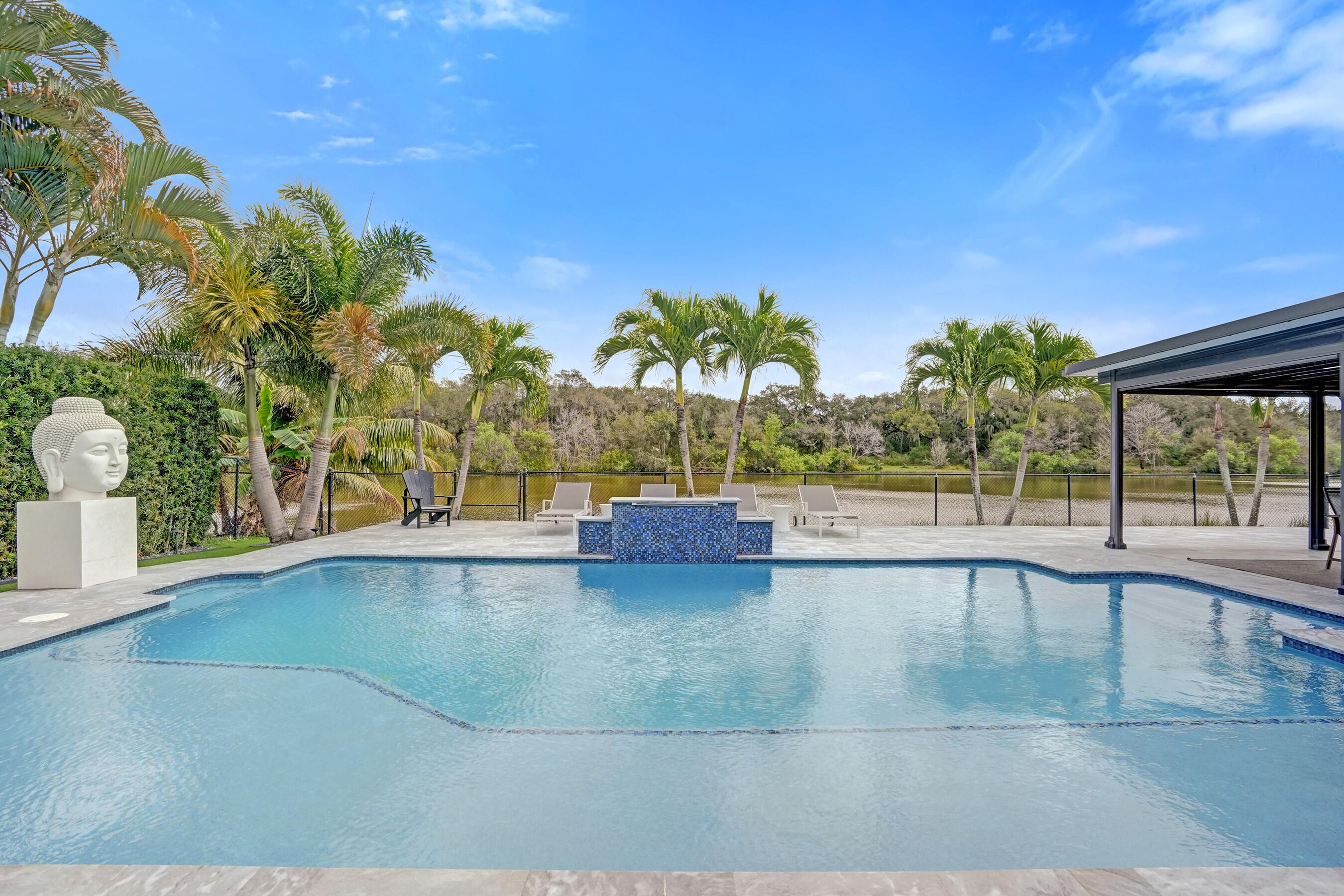 3222 Ridge Trace Davie, FL 33328 - Photo 66 of 77 a view of a swimming pool and a yard