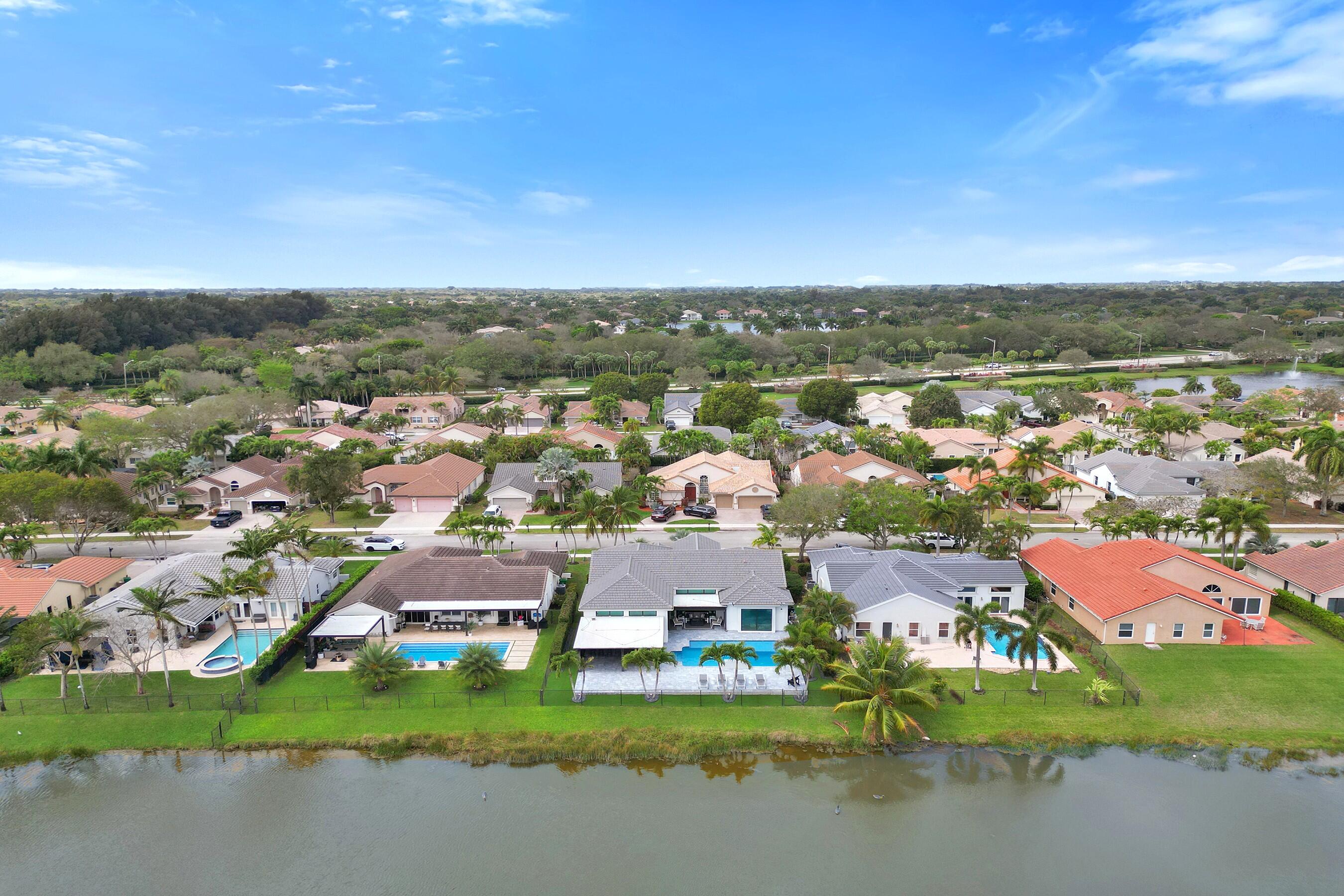 3222 Ridge Trace Davie, FL 33328 - Photo 75 of 77 an aerial view of residential houses with outdoor space and lake view