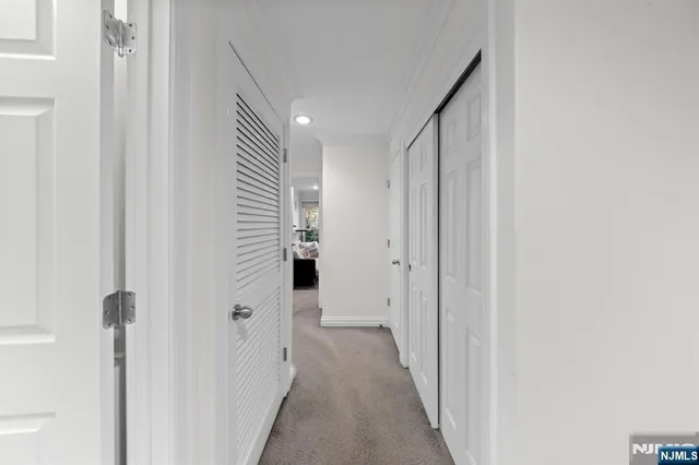 a spacious bedroom with a bed and a flat screen television