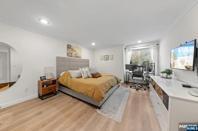 a bedroom with furniture and a wooden floor