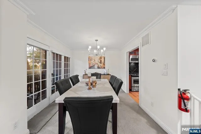 a view of a dining room with furniture and window