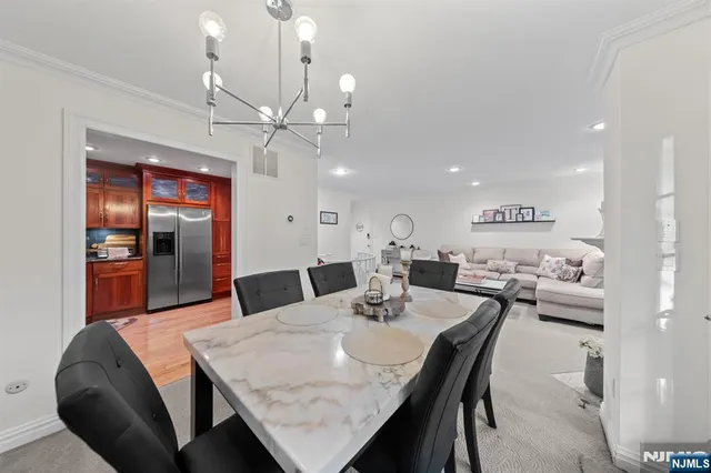 a view of a dining room with furniture and a chandelier