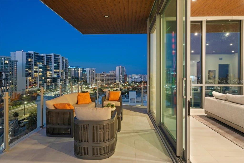 111 Golden Gate Point, Unit 802PH Sarasota, FL 34236 - Photo 15 of 55 a outdoor dining space with furniture and city view