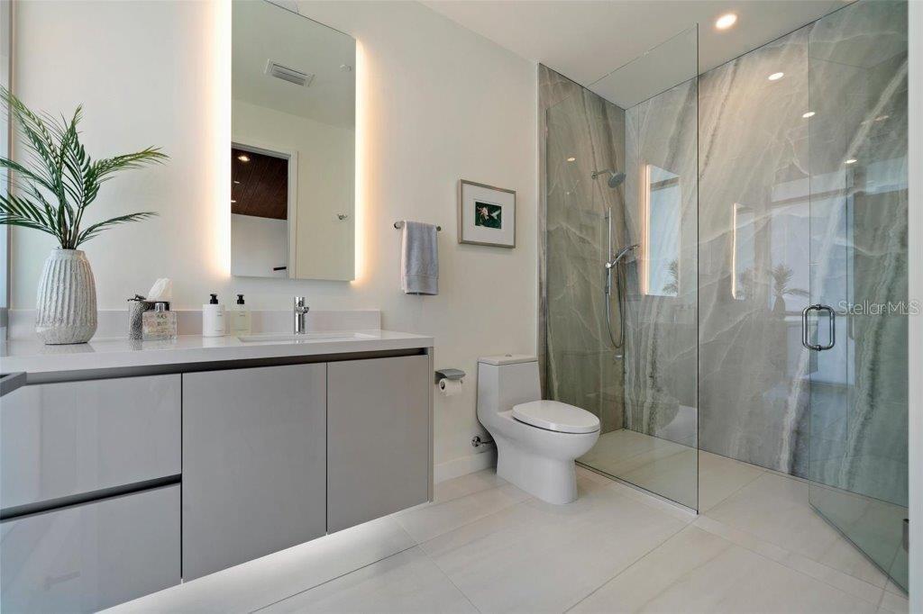 111 Golden Gate Point, Unit 802PH Sarasota, FL 34236 - Photo 24 of 55 a bathroom with a toilet sink and shower