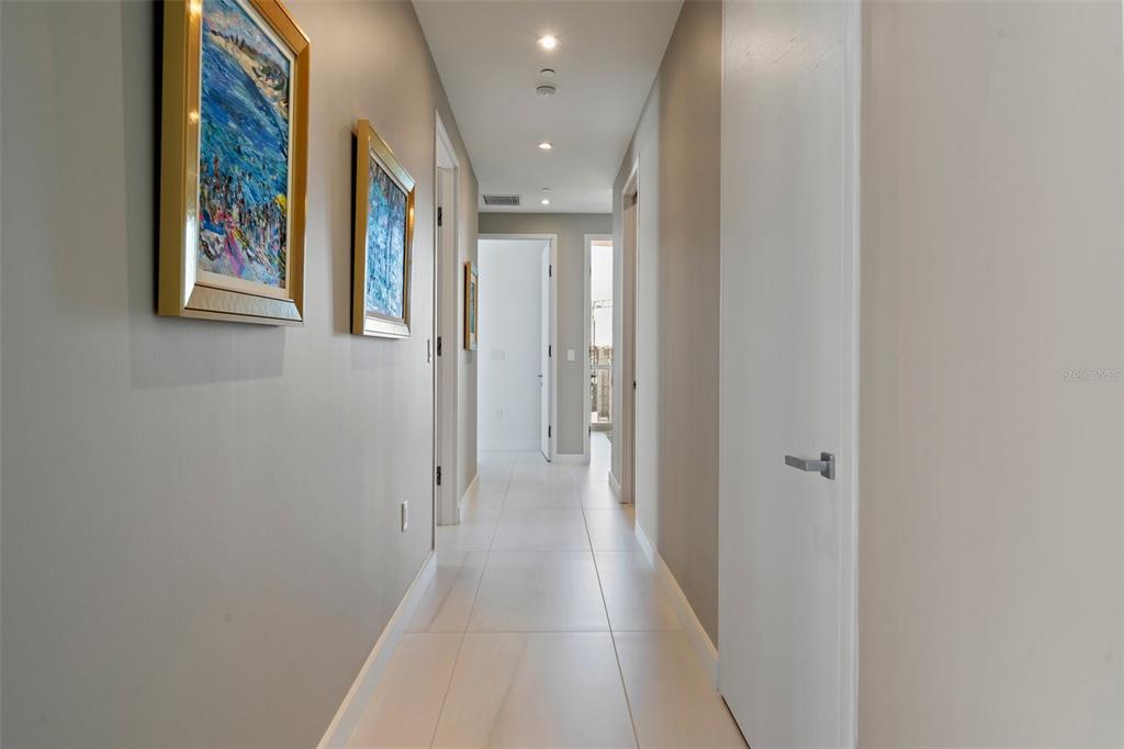 111 Golden Gate Point, Unit 802PH Sarasota, FL 34236 - Photo 25 of 55 a view of a hallway with wooden floor