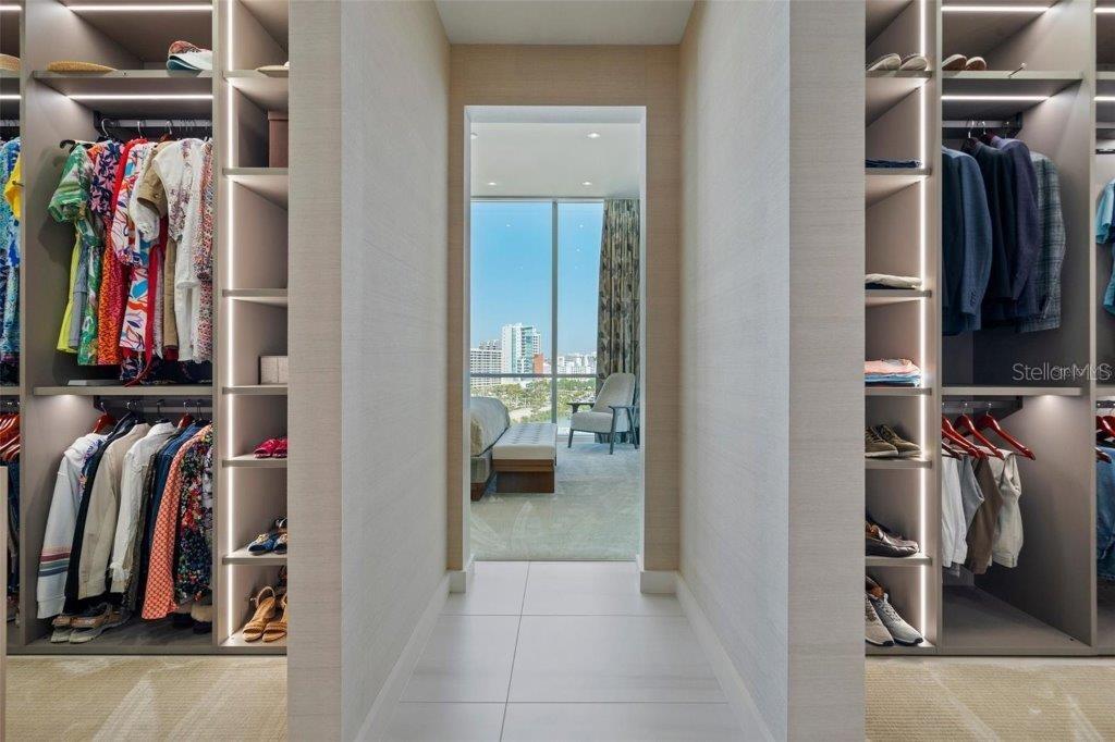 111 Golden Gate Point, Unit 802PH Sarasota, FL 34236 - Photo 27 of 55 a view of walk in closet with clothes and shoes