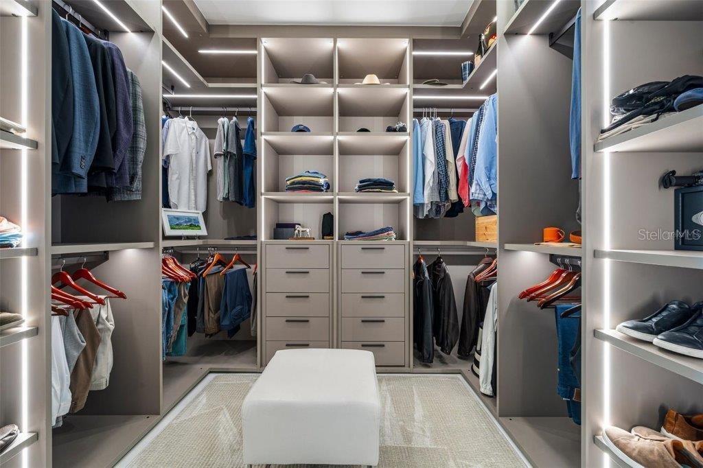 111 Golden Gate Point, Unit 802PH Sarasota, FL 34236 - Photo 31 of 55 a view of walk in closet with clothes and shoes