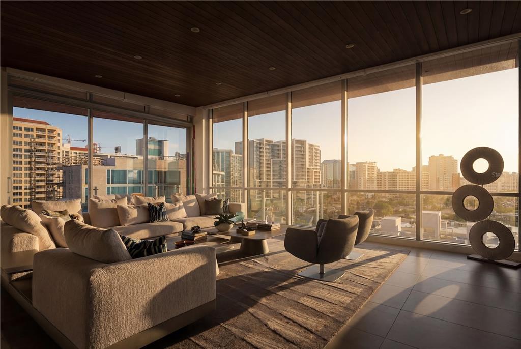 111 Golden Gate Point, Unit 802PH Sarasota, FL 34236 - Photo 5 of 55 a living room with furniture and a floor to ceiling window