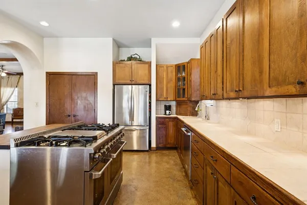 a kitchen with a stove a sink and a refrigerator