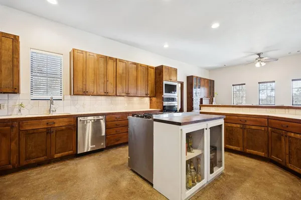 a kitchen with stainless steel appliances granite countertop a stove and a sink