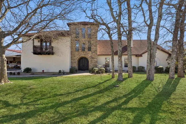 a house view with a sitting space and garden