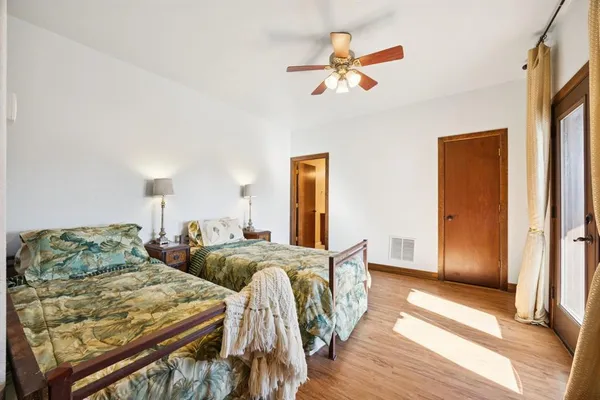 a bedroom with two beds and a chandelier