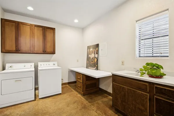 a room with a sink cabinets and window