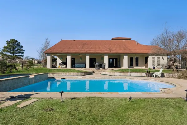 a house with swimming pool in front of it